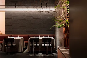 Industrial-style restaurant interior with brick walls and leather booths