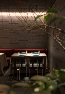 Industrial-themed restaurant with brick walls and metal furniture and fixtures.