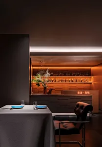 A modern industrial restaurant interior with concrete walls and minimalist decor.