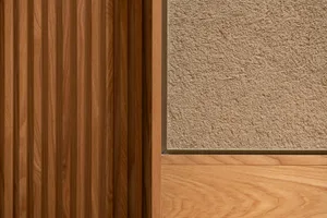 A minimalist interior with wooden panels and textured plaster walls.
