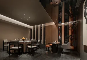Modern restaurant interior with concrete walls, wooden furniture, and glass elements.
