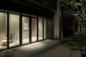 Modern retail storefront with glass doors and interior lighting.