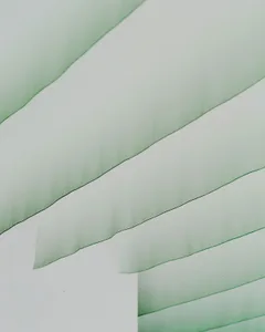 White interior with green curtains and drapes
