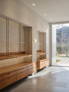 A minimalist interior featuring wooden cabinets and shelves.