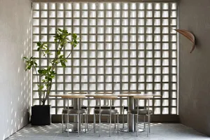 A modern cafe interior with glass block walls and concrete flooring.