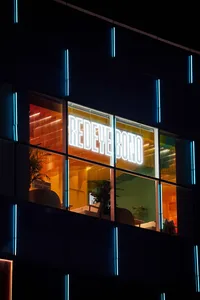 An office building with a modern glass exterior at night.