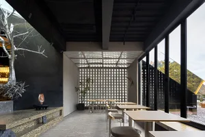 Modern restaurant interior featuring metal and concrete elements for a contemporary design.