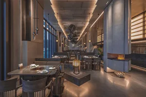 Modern restaurant interior featuring metal, wood, and stone materials.