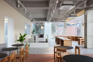 Modern industrial cafe interior with concrete floor and minimalist design.