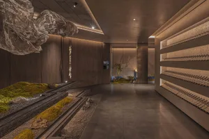 An elegant, minimalist spa interior designed with concrete elements, featuring a floating sculpture and a serene atmosphere.