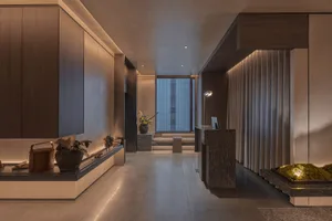 Modern residential entryway featuring wooden cabinets, concrete floor, and grey curtains.