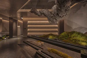 An industrial modern interior bar with concrete walls, glass shelves, and wooden elements.