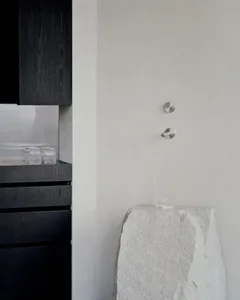 A minimalist interior design featuring modern elements made of glass and marble.