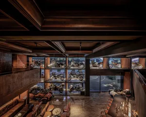 Industrial-looking motorcycle showroom featuring glass, wood, and metal elements.