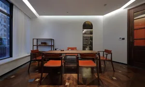 A minimalist dining room with wooden furniture and a large window.