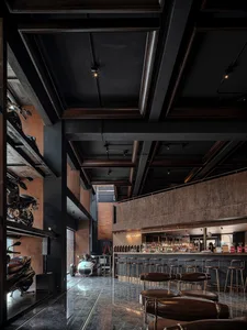 Modern coffee shop interior with concrete, wood, metal, and glass materials.