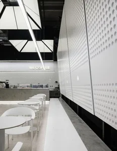 Modern coffee shop with minimalist design, white materials and bar counter.