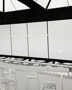 Modern minimalist coffee shop featuring white surfaces