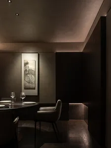A minimalist restaurant interior with an auto-themed design and metallic flooring.