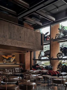 Modern bar featuring exposed brick walls and concrete surfaces
