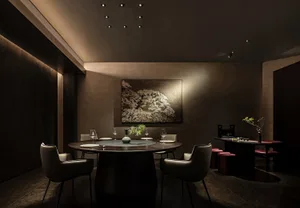 Modern restaurant dining room features metal, wood, and leather materials.