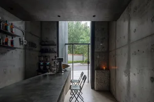 Industrial-styled coffee shop bar with concrete desk and minimalist design