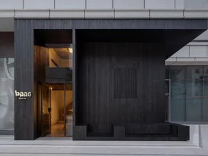 Modern storefront featuring dark wood panels and glass windows.