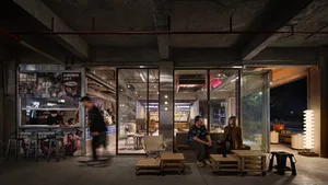 Industrial-style coffee shop with concrete walls and glass partitions