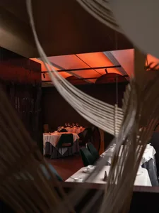 Interior view of an industrial-themed restaurant showcasing metallic textiles as a feature.
