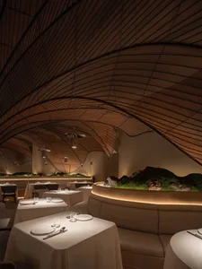 A modern restaurant interior with wooden materials and a sophisticated design.