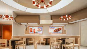 Modern restaurant interior featuring wooden furniture, laminate walls, and ceramic tile flooring.