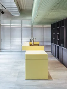 A minimalist bar counter featuring a yellow cube shape.