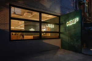 The facade of a modern storefront featuring a combination of brick and glass materials, showcasing a contemporary architectur