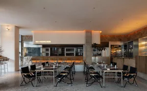 Modern restaurant interior with concrete walls and contemporary design elements