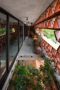 Modern architecture featuring exposed brick walls and large glass windows.