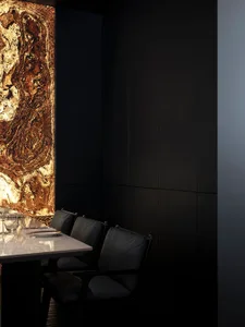 Modern restaurant interior featuring a striking marble wall
