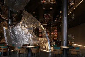 Metallic interior design of a restaurant with modern chairs and tables.