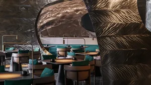 Restaurant interior with metallic textured walls and turquoise accents