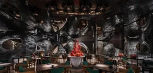 Industrial-style restaurant interior featuring metallic walls and furniture.