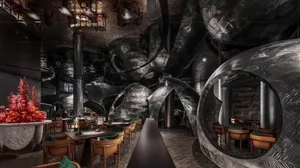 Metallic, modern-look restaurant interior with glass, wood, and marble accents.