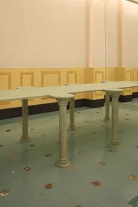 A modern office space featuring concrete tables with geometric designs.