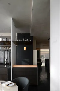 Black minimalist interior with metallic accents and dark wood furniture