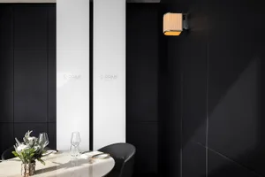 The image showcases a modern restaurant dining room with dark black walls, white accents, and a minimalist design aesthetic.