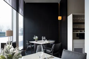 Modern minimalist restaurant interior with black and white color scheme, featuring contemporary furniture and sleek design el