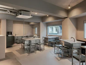 A modern commercial space with minimalist design and metal furnishings.