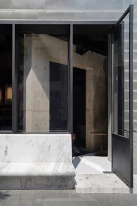 Concrete and marble architectural entry with glass elements.