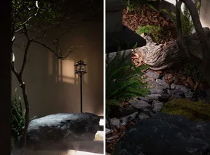 A serene minimalist garden interior featuring stone and wooden elements.