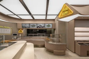 Modern interior of a bakery shop with wooden elements and shelves.
