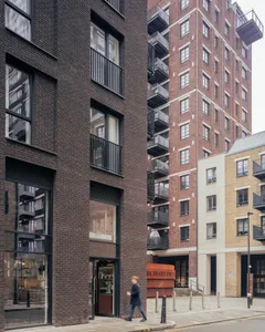 Modern brick buildings with balconies in a street view.