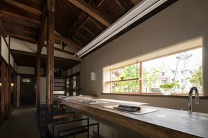 Modern interior space featuring wooden counter with white countertops in minimalist design.